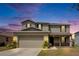 Two-story home featuring a gray exterior, attached garage, and well-manicured lawn at 11136 Hartford Fern Dr, Riverview, FL 33569