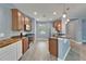 Bright kitchen features wood cabinets, stainless steel appliances, mosaic backsplash, granite counters, and an open floor plan at 11136 Hartford Fern Dr, Riverview, FL 33569