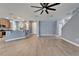 Spacious open-concept living room with wood floors, open layout, and a staircase at 11136 Hartford Fern Dr, Riverview, FL 33569