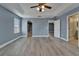 Expansive primary bedroom with a tray ceiling, natural light, and two doorways to other rooms at 11136 Hartford Fern Dr, Riverview, FL 33569