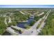 Aerial view featuring a scenic pond, community entrance, and well-maintained roads surrounded by lush trees at 11607 Meridian Point Dr, Tampa, FL 33626