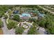 Aerial view showcases the community clubhouse amenities including a pool, tennis courts, and lush landscaping at 11607 Meridian Point Dr, Tampa, FL 33626