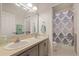 Bathroom featuring double sinks and a tub/shower combo with a decorative shower curtain at 11607 Meridian Point Dr, Tampa, FL 33626