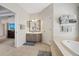 Bathroom featuring a soaking tub, walk-in shower, vanity, and tile flooring at 11607 Meridian Point Dr, Tampa, FL 33626