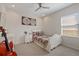 Cozy bedroom with a single bed, world map wall art, and natural light from the window at 11607 Meridian Point Dr, Tampa, FL 33626