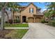 Charming two-story home with a well-manicured lawn, mature trees, and a two-car garage at 11607 Meridian Point Dr, Tampa, FL 33626