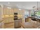 Eat-in kitchen featuring stainless steel appliances, granite countertops, an island, and abundant cabinet space at 11607 Meridian Point Dr, Tampa, FL 33626