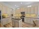 Kitchen featuring granite countertops, tile backsplash, stainless steel appliances, and ample cabinet space at 11607 Meridian Point Dr, Tampa, FL 33626