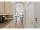 Galley kitchen with granite countertops, stainless steel appliances, ample storage, and hardwood floors at 11607 Meridian Point Dr, Tampa, FL 33626