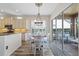 Open kitchen with a breakfast bar flowing into the dining area and sliding doors leading to the patio at 11607 Meridian Point Dr, Tampa, FL 33626