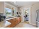 Features a kitchenette with granite countertops, stainless steel refrigerator, and a pool view at 11607 Meridian Point Dr, Tampa, FL 33626