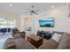 Spacious Gathering room featuring comfortable seating, a media center, and sliding doors to the outside patio at 11607 Meridian Point Dr, Tampa, FL 33626