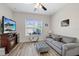 Comfortable living area with fireplace, sofa, window, and a ceiling fan at 11607 Meridian Point Dr, Tampa, FL 33626