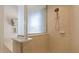 Modern shower featuring tan tile and a glass enclosure at 11607 Meridian Point Dr, Tampa, FL 33626