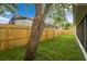 Grassy backyard enclosed by a new wooden fence, creating a private outdoor space at 11626 Pure Pebble Dr, Riverview, FL 33569