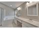 Bathroom with double sinks, ample counter space, and soaking tub at 11626 Pure Pebble Dr, Riverview, FL 33569