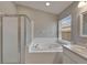 Bathroom featuring a jacuzzi tub, shower, and neutral color palette at 11626 Pure Pebble Dr, Riverview, FL 33569