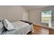 Bright bedroom featuring wood flooring and a window with natural light at 11626 Pure Pebble Dr, Riverview, FL 33569