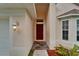 Close-up view of home entryway, with a covered porch, stylish door, and manicured landscaping at 11626 Pure Pebble Dr, Riverview, FL 33569