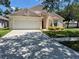Charming single-Gathering home featuring an attached two-car garage and well-maintained front lawn at 11626 Pure Pebble Dr, Riverview, FL 33569