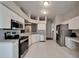Kitchen featuring stainless steel appliances, white cabinetry, and tile flooring at 11626 Pure Pebble Dr, Riverview, FL 33569