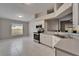 Bright kitchen with white cabinets, stainless steel appliances, and tile floors at 11626 Pure Pebble Dr, Riverview, FL 33569