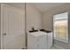 Bright laundry room features a full size washer and dryer at 11626 Pure Pebble Dr, Riverview, FL 33569