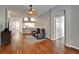 Open concept living room with wood floors, neutral colors, theater seating, and view to the entryway at 11626 Pure Pebble Dr, Riverview, FL 33569
