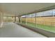 Enclosed patio with concrete floor, screen, and backyard view, perfect for outdoor relaxation at 11626 Pure Pebble Dr, Riverview, FL 33569