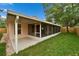 A covered patio overlooks the grassy backyard, perfect for outdoor living at 11626 Pure Pebble Dr, Riverview, FL 33569
