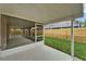 Enclosed patio with concrete floor, screen, and backyard view, perfect for outdoor relaxation at 11626 Pure Pebble Dr, Riverview, FL 33569