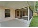 Enclosed patio with screen door offering access to a well-maintained backyard at 11626 Pure Pebble Dr, Riverview, FL 33569