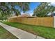 Well-maintained lawn with a wooden fence, adding privacy and curb appeal at 11626 Pure Pebble Dr, Riverview, FL 33569