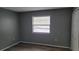 Cozy bedroom featuring laminate wood floors and a window for natural light at 12041 Environmental Dr # 6, New Port Richey, FL 34654