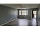 Open living room featuring wood floors, a ceiling fan, and natural light at 12041 Environmental Dr # 6, New Port Richey, FL 34654