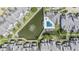 Aerial view of the community with a pool, pond and well maintained landscaping at 12233 Armenia Gables Cir # 12233, Tampa, FL 33612
