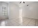 A well-lit bedroom with neutral walls, tile floors, and a large window at 12233 Armenia Gables Cir # 12233, Tampa, FL 33612