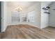 Bright dining room with wood floors, a chandelier, and three windows at 12233 Armenia Gables Cir # 12233, Tampa, FL 33612