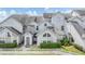 Charming townhome with light gray facade, well-manicured landscaping, and a white picket fence for added curb appeal at 12233 Armenia Gables Cir # 12233, Tampa, FL 33612