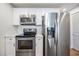 Updated kitchen features stainless steel appliances and white cabinetry at 12233 Armenia Gables Cir # 12233, Tampa, FL 33612