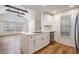 Modern kitchen with stainless steel dishwasher and white cabinets at 12233 Armenia Gables Cir # 12233, Tampa, FL 33612