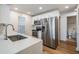Bright kitchen boasts stainless steel appliances and white subway tile backsplash at 12233 Armenia Gables Cir # 12233, Tampa, FL 33612