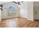 Bright living room features vaulted ceilings, a large arched window, and light wood-look flooring for an inviting space at 12233 Armenia Gables Cir # 12233, Tampa, FL 33612