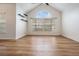 Spacious living room featuring vaulted ceilings, a large arched window, wood-look flooring and open design at 12233 Armenia Gables Cir # 12233, Tampa, FL 33612