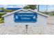 Carrollwood Gables Condominiums sign provides easy identification with palm tree detail in blue and white color scheme at 12233 Armenia Gables Cir # 12233, Tampa, FL 33612