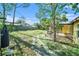 View of a large backyard with trees, a screened patio, and space for landscaping at 1349 Foxboro Dr, Brandon, FL 33511