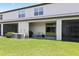 Exterior back porch with manicured lawn and two air conditioning units near a screened lanai at 14323 Easy Goer St, Ruskin, FL 33573