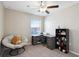 Bedroom with carpet, ceiling fan, desk, and a stuffed animal at 14323 Easy Goer St, Ruskin, FL 33573