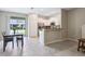 Open-concept dining area with a view to the backyard and access to the kitchen at 14323 Easy Goer St, Ruskin, FL 33573