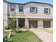 Charming townhome boasts a well-maintained front yard, two-car garage, and tasteful landscaping at 14323 Easy Goer St, Ruskin, FL 33573